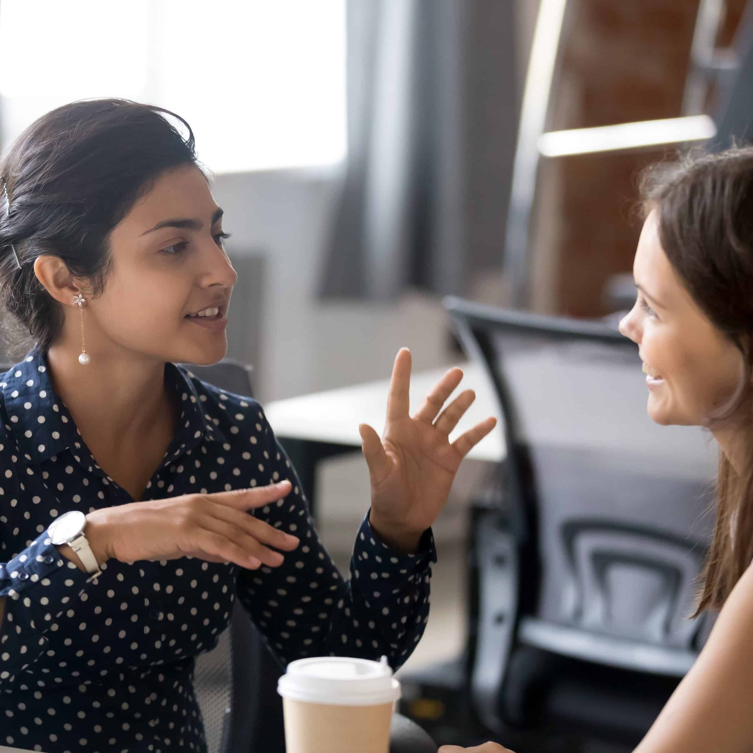 Two women discussing strategies and technologies as part of a dyslexia workplace needs assessment